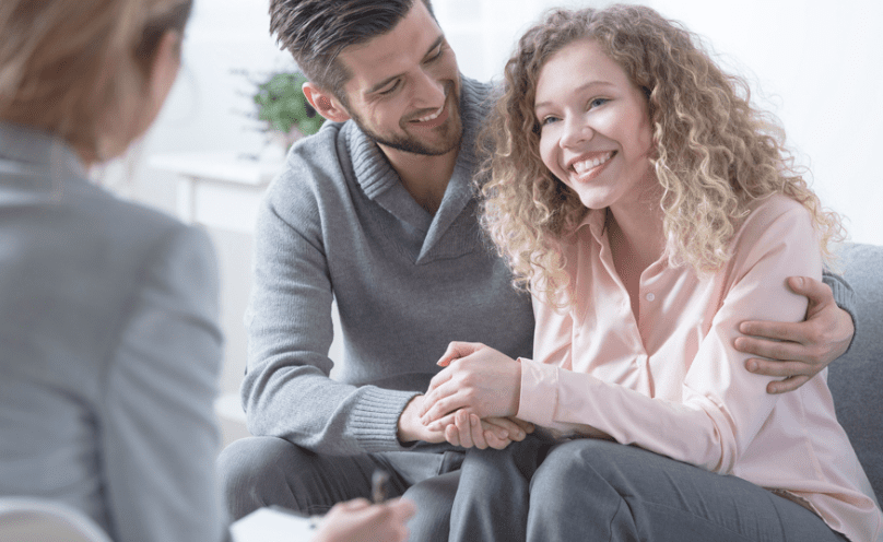 A smiling couple in family therapy