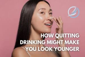 an image of female with glowing skin since she has quit drinking alcohol to look younger on a pink background.