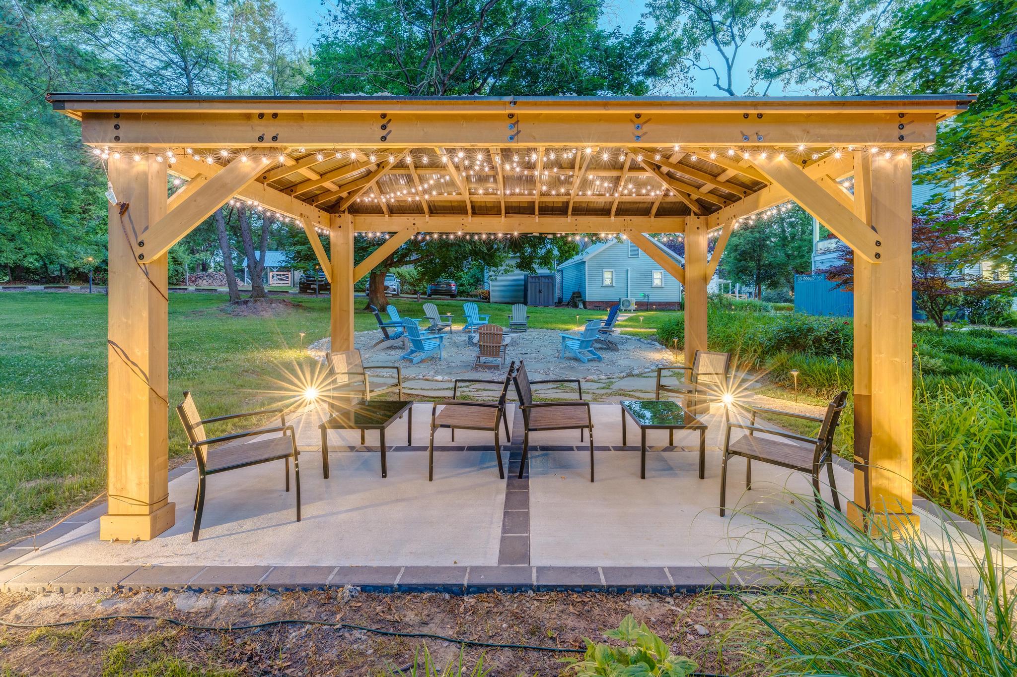 The Freedom Center's cozy pergola and fire pit at dusk.